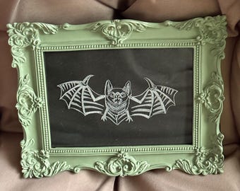 Gravure traditionnelle américaine de chauve-souris dans un cadre vert