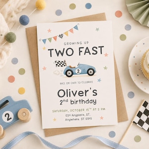 May include: A rectangular birthday invitation card featuring a blue race car with the number 2, a chequered flag, and colourful bunting. The text reads: GROWING UP TWO FAST, Oliver's 2nd birthday, Saturday, October 15th at 2 PM, 1234 Anyplace, ST.