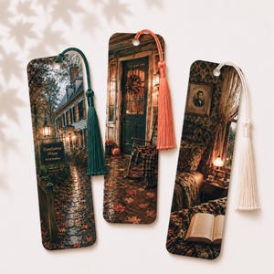 May include: Three rectangular bookmarks featuring autumn-themed scenes. The first shows a house with a sign reading Hawthorne House Bed & Breakfast and a dark green tassel. The second depicts a porch with a rocking chair and orange tassel. The third shows a bedroom interior with a white tassel.