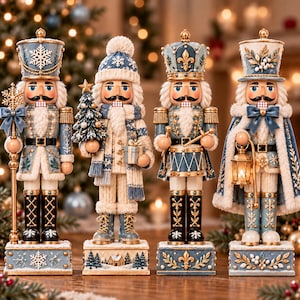 May include: Four decorative nutcracker figurines in shades of blue, white, and gold. Each figure wears a detailed uniform with snowflake, floral, or winter motifs. They hold accessories including a staff, a tree, a drum, and a lantern.