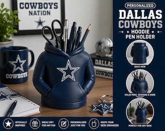 May include: A navy blue pen holder shaped like a hoodie featuring a white Dallas Cowboys star logo on the front. The desk organizer has a hood opening for storing pens, pencils, and scissors. Text on the image includes Personalized Dallas Cowboys Hoodie Pen Holder, Back View, Holds Pens, Scissors & More, and Perfect For Any Desk.