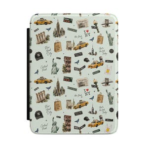 May include: A rectangular e-reader case with a light green background featuring a repeating pattern of New York City icons including yellow taxis, the Statue of Liberty, the Brooklyn Bridge, skyscrapers, street signs, and the text I Love NY.