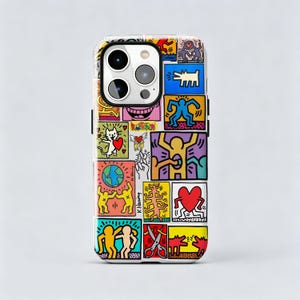 May include: A smartphone case featuring a vibrant collage of Keith Haring's iconic pop art illustrations. The design includes colorful panels with dancing figures, a red heart, a globe, a cat, and scissors, all outlined in bold black lines.