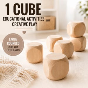 May include: Several large, rounded wooden cubes are arranged on a light-colored surface. The cubes have a natural wood grain finish. Text in the image reads "1 CUBE, EDUCATIONAL ACTIVITIES, CREATIVE PLAY" and "LARGE ROUNDED CUBE FOR LITTLE HANDS."