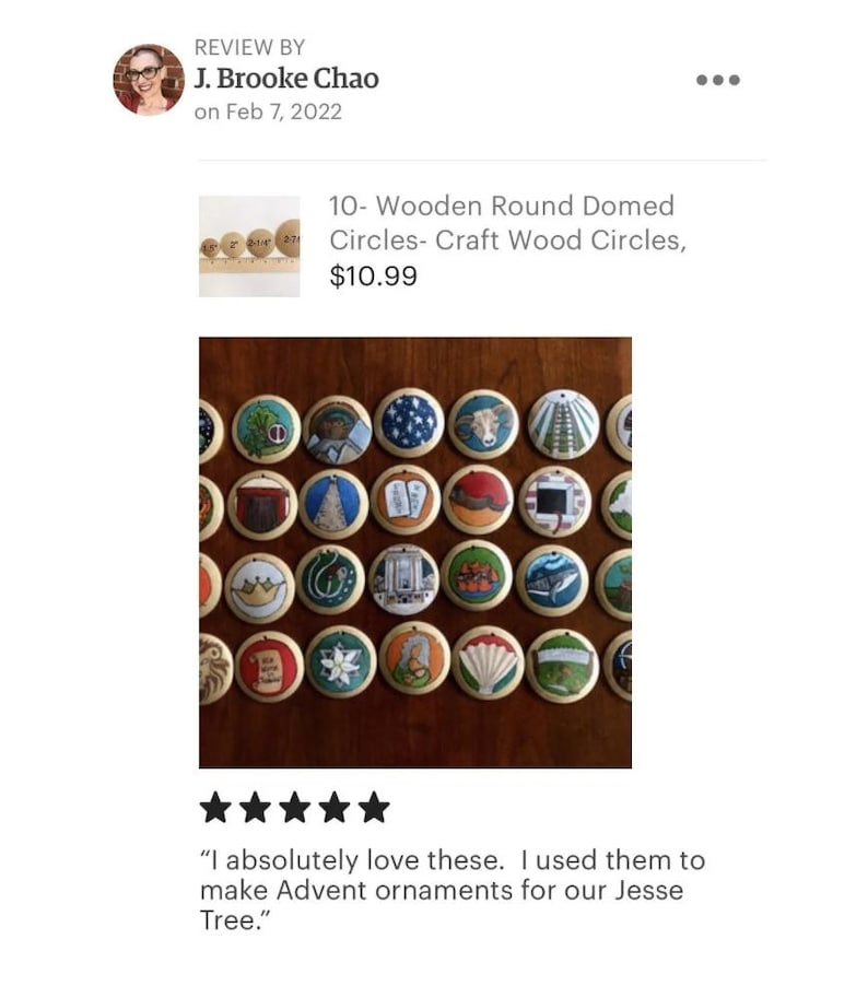 May include: A collection of small, round, domed wooden discs, each featuring a unique hand-painted illustration. The designs include various symbols, animals, and objects, all arranged in a grid pattern. Each disc has a small hole at the top.