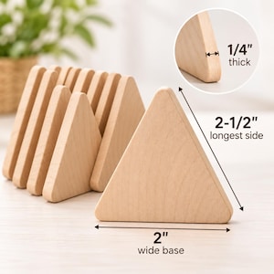May include: A set of light-colored wooden triangles. One triangle is in the foreground with a 2-inch wide base and a 2-1/2-inch longest side. An inset shows the thickness is 1/4-inch. Several other identical wooden triangles are stacked behind.