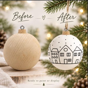 May include: Two round ornaments with metal loops and twine. The left ornament is plain light wood. The right ornament is painted white with a black line drawing of a village scene featuring houses and dots. Text reads Before, After, and Ready to paint or display.