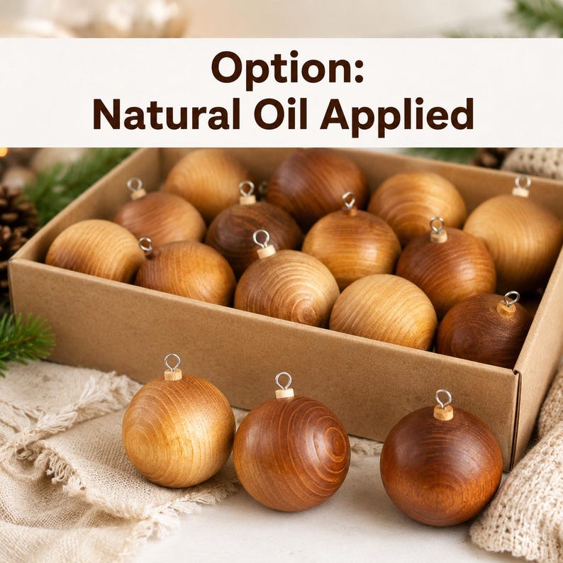 May include: A collection of spherical wooden ornaments with a natural oil finish, featuring visible wood grain patterns and silver-toned metal hanging loops. The ornaments are presented in a rectangular cardboard box with text reading Option: Natural Oil Applied.