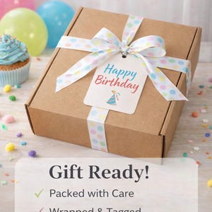 May include: A brown gift box tied with a white ribbon featuring colorful polka dots. A tag with "Happy Birthday" is attached. The image includes balloons, a cupcake, and the text "Gift Ready!"