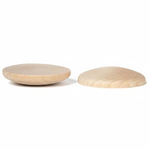 May include: Two circular wooden objects with a light beige color and visible natural wood grain. One object is positioned with its flat side facing upward, while the other is placed with its rounded, convex side facing upward on a white background.