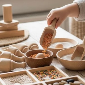 May include: Wooden sensory play set with bowls, scoops, and various materials like lentils and sand. The set includes a variety of wooden shapes and containers, perfect for early childhood development and educational play.