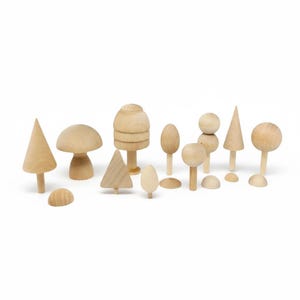 May include: A collection of natural light-colored wooden figures in various shapes including conical trees, rounded mushroom-like forms, spherical tops on stems, and small semi-circular pieces arranged together on a plain white background.