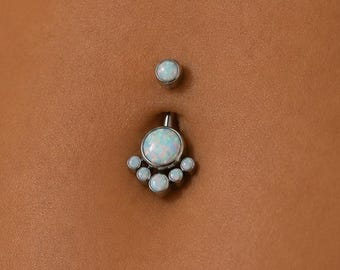 May include: A silver-toned navel piercing jewelry piece featuring a small round opal top bead and a larger bottom charm. The bottom charm consists of a central round opal stone surrounded by five smaller round opal accents in a fan-like arrangement.