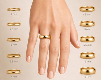 May include: A hand wearing a gold wedding band, with a selection of gold rings of varying widths displayed nearby. The rings range from 2 mm to 7 mm in width, showcasing different size options for potential buyers.