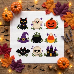 May include: A white fabric square featuring a cross-stitch pattern of nine Halloween icons: a black cat, a white ghost, an orange jack-o'-lantern, a purple witch hat, a black cauldron, candy corn, a black bat, a skull, and a purple castle.