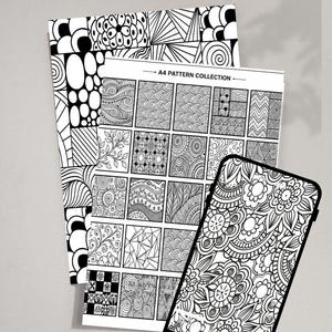 May include: A 30 pages PDF document featuring black and white line art patterns. The collection includes sheets with geometric shapes, floral motifs, and abstract designs. A smartphone displays one of the intricate floral patterns on its screen.