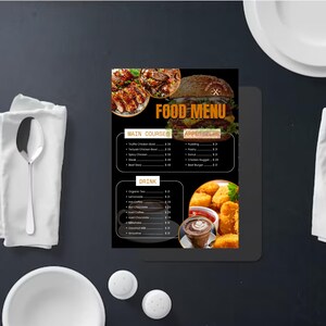 May include: A rectangular food menu printed on a black background with the title FOOD MENU in orange. It features images of a burger, chicken, and nuggets. The menu lists main courses, appetizers, and drinks with prices in dollars and white text.