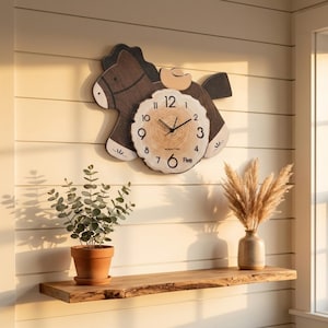 May include: A wall clock shaped like a dark brown horse with a light-colored wooden log slice face. The clock features black hour and minute hands, black numerals from 1 to 12, and the word Five written near the number 5 on the clock face.