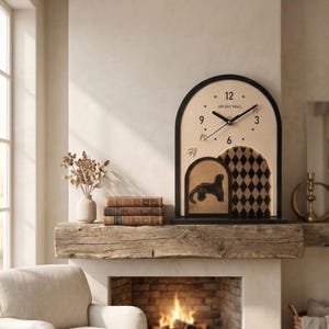 May include: An arched wall clock with a black frame and a beige face featuring the text UNI-BUT MALL. The clock has black hands, numerical markers for 3, 6, 9, and 12, and a lower section with a black leopard silhouette and a black diamond pattern.