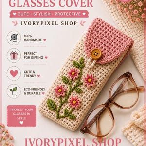 May include: A handmade crochet glasses cover in cream with a pink flap and a wooden button closure. The front features embroidered pink flowers with green stems and leaves. A pair of brown-rimmed glasses rests beside the cover on a textured surface.