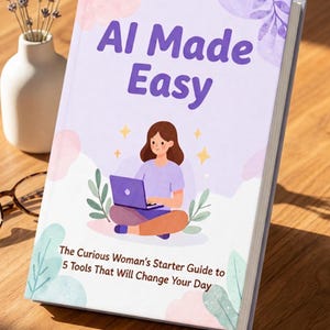 May include: A book titled "AI Made Easy" with a woman using a laptop on the cover. The book has a light purple background with floral and abstract designs. The text below reads "The Curious Woman's Starter Guide to 5 Tools That Will Change Your Day."