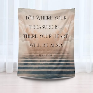 May include: A rectangular blanket with a design featuring a stairway leading upwards into a cloudy sky. The blanket has the text "FOR WHERE YOUR TREASURE IS... THERE YOUR HEART WILL BE ALSO. LUKE 12:34" printed on it.