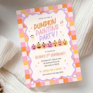 May include: A rectangular invitation card featuring a pink and orange checkered border. The center has a wavy purple frame containing the text JOIN US FOR A PUMPKIN PAINTING PARTY, OLIVIA'S 5TH BIRTHDAY, OCTOBER 25TH, 20XX AT 4PM, 52 PUMPKIN PATCH RD, NEW YORK, NY 90210, DRESS FOR A MESS, AND RSVP MOM AT 123-456-7890, with illustrations of pumpkins and paintbrushes.