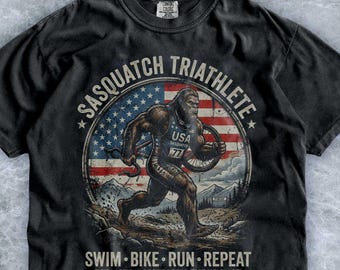 Sasquatch Triathlete American Flag Shirt, Vintage Bigfoot Swim Bike Run Graphic Tee, Retro Cryptid USA Endurance Top