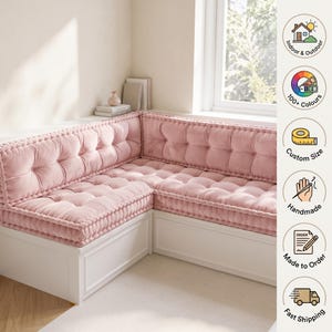 May include: A light pink tufted L-shaped bench cushion set featuring a thick, soft texture with button detailing. The cushion is placed on a white corner bench. The right side includes icons for Indoor & Outdoor, 100+ Colours, Custom Size, Handmade, Made to Order, and Fast Shipping.