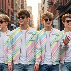 May include: Four people wearing sunglasses and pastel striped bomber jackets, white t-shirts, and ripped blue jeans walk down a city street. They are surrounded by photographers and reporters with microphones and cameras.