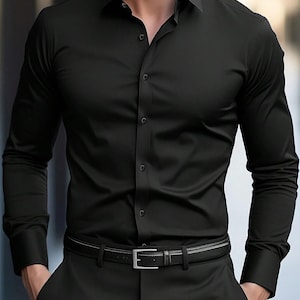 May include: A solid black long-sleeve button-down shirt with a pointed collar and matching black buttons. The shirt is tucked into black trousers secured with a black leather belt featuring a silver-toned rectangular metal buckle.