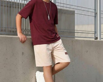 Conjunto de camiseta y pantalón corto deportivo burdeos con estampado de letras para adolescentes, corte holgado, ideal para el verano.