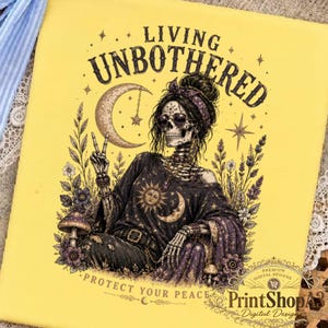 May include: A yellow t-shirt featuring a graphic of a skeleton wearing sunglasses and a headscarf, making a peace sign. The text reads LIVING UNBOTHERED and PROTECT YOUR PEACE. The design includes a crescent moon, stars, flowers, and mushrooms.