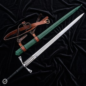 May include: A steel longsword with a black grip, a ring pommel, and a crossguard featuring clover-shaped terminals. The sword is accompanied by a green scabbard with brown leather straps and a matching brown leather belt with metal buckles.
