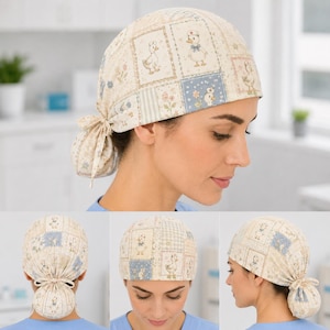 May include: A scrub cap featuring a patchwork pattern of cream, light blue, and beige squares. The fabric displays illustrations of ducks, flowers, and gingham checks. The cap includes a gathered back section with a tie closure for adjustment.