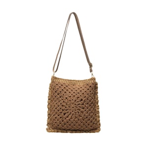 May include: A square-shaped crochet shoulder bag in a medium brown yarn featuring a textured, radiating starburst pattern. The bag includes a thin, adjustable brown strap attached with metal hardware at the top corners of the square body.