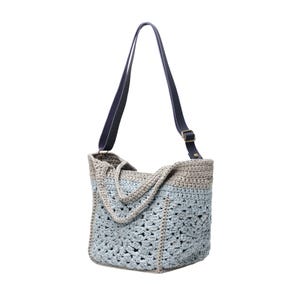 May include: A handmade crochet tote bag in shades of blue and gray, featuring a geometric openwork design. The bag has a dark blue leather strap with a brass buckle. The tote is designed for carrying items.