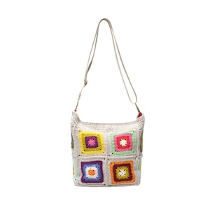 May include: An off-white crochet shoulder bag with a long strap. The bag is decorated with colourful square patterns in shades of yellow, purple, green, orange, and pink. The strap is a light beige colour, and the bag has a soft, textured appearance.