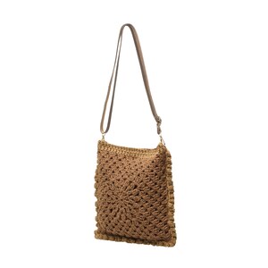 May include: A square-shaped crochet shoulder bag in a medium brown yarn. The bag features a textured, radiating star-like pattern on the front panel, a solid border, and a thin, adjustable brown strap attached with gold-toned metal hardware.
