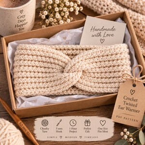 May include: A beige crochet twisted ear warmer in a cardboard gift box with a card reading Handmade with Love, a tag reading Crochet Twisted Ear Warmer PDF PATTERN, a 5.0 mm crochet hook, and a mug with the text Cozy Days Happier You.
