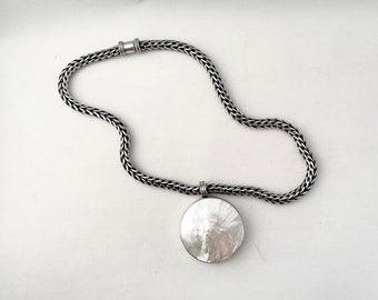 Vintage Dina Mackney 2" round mother of pearl pendant paired with Suarti heavy 925 woven chain, includes Dina Mackney velvet pouch