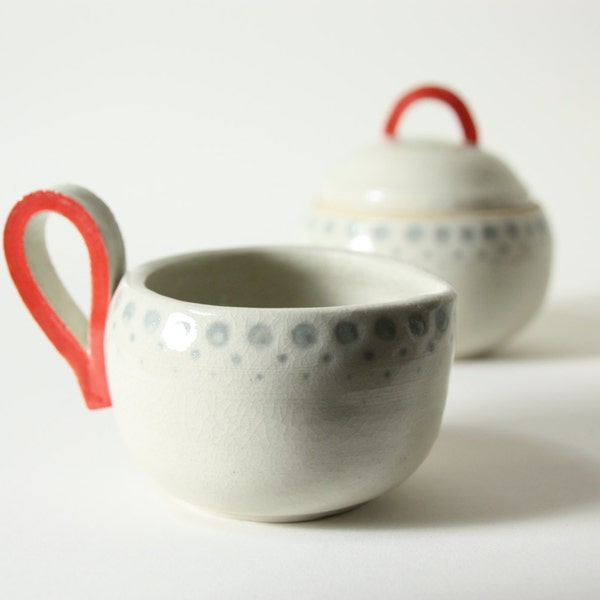 fun modern cream and sugar set - hand thrown porcelain with minimalist clear crackle, happy grey dots, and loud red loop handles