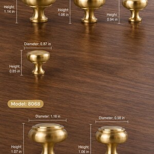May include: A collection of brass cabinet knobs in two styles, Model 8067 and 8068, with labeled dimensions in inches. Model 8067 includes four sizes with diameters from 0.87 to 1.38 inches. Model 8068 includes two sizes with diameters of 0.98 and 1.18 inches.