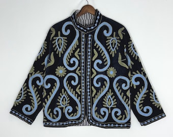 May include: A black long-sleeve jacket featuring a mandarin collar and an intricate embroidered pattern in light blue and olive green. The design consists of swirling scrollwork, floral motifs, and linear borders along the front opening.