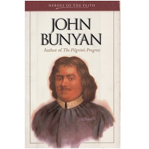 May include: A book cover featuring a portrait of John Bunyan, the author of "The Pilgrim's Progress". The cover is white with a red banner at the top that reads "Heroes of the Faith".