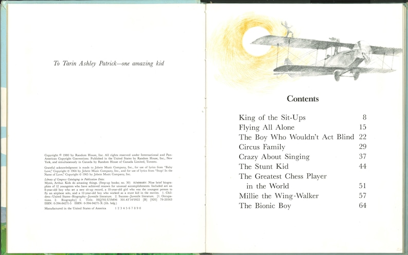 May include: An open book with illustrations and text. The left page reads "To Tarin Ashley Patrick&mdash;one amazing kid." The right page features a drawing of a biplane and the table of contents, including titles like "Flying All Alone" and "The Bionic Boy."