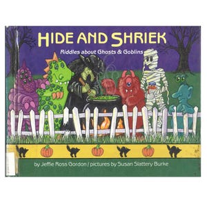 May include: A children's book titled "HIDE AND SHRIEK" with the subtitle "Riddles about Ghosts & Goblins." The cover features colorful cartoon monsters, a witch stirring a cauldron, and a white picket fence against a purple night sky.