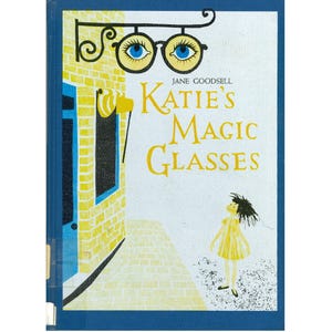 May include: A vintage book cover titled "Katie's Magic Glasses" by Jane Goodsell. The cover features a whimsical illustration of eyeglasses with blue eyes, a yellow brick building, and a girl in a yellow dress looking up.