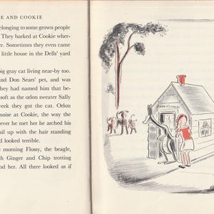 May include: A black and white illustration of a girl standing in front of a small house with a red roof. A kangaroo stands next to her, and a cat sits on the ground nearby. The house has a sign that reads "Cookie's House".
