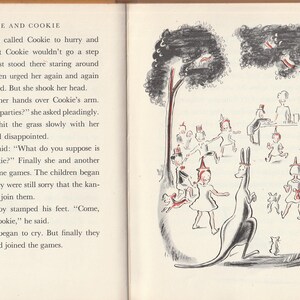 May include: A black and white illustration of children playing in a park with a kangaroo. The children are wearing hats and are playing games. The kangaroo is standing in the middle of the picture. The text "Evie and Cookie" is at the top of the page.